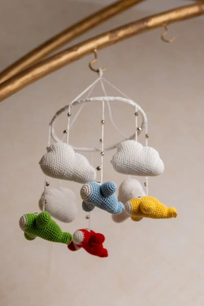 Crochet airplane cot hanging showing full mobile width with multiple colourful aircraft handmade nursery decor Australia