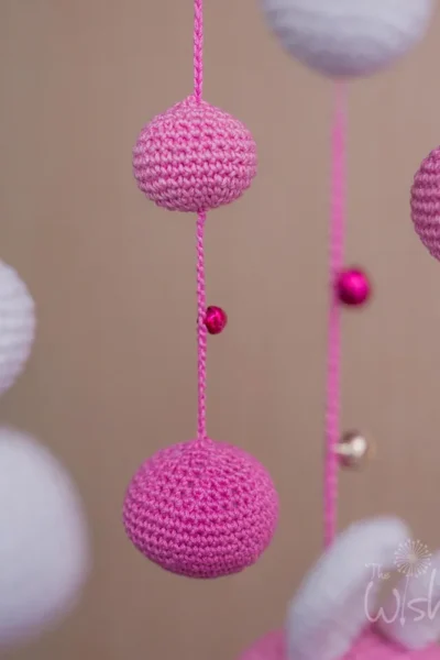 Handmade crochet pink doll nursery mobile in soft pink tones made by artisan women in India Australia