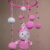Handmade crochet pink doll nursery mobile in soft pink tones made by artisan women in India Australia