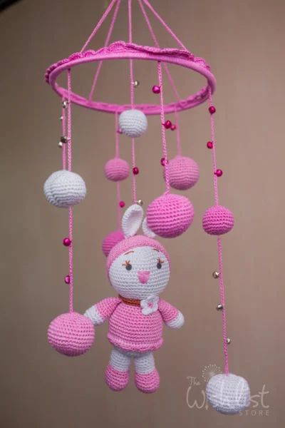 Handmade crochet pink doll nursery mobile in soft pink tones made by artisan women in India Australia