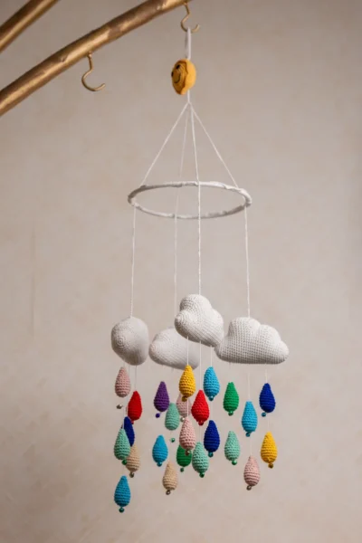 Crochet cloud and raindrops cot hanging showing full mobile with colourful raindrop strands handmade ethical nursery decor Australia