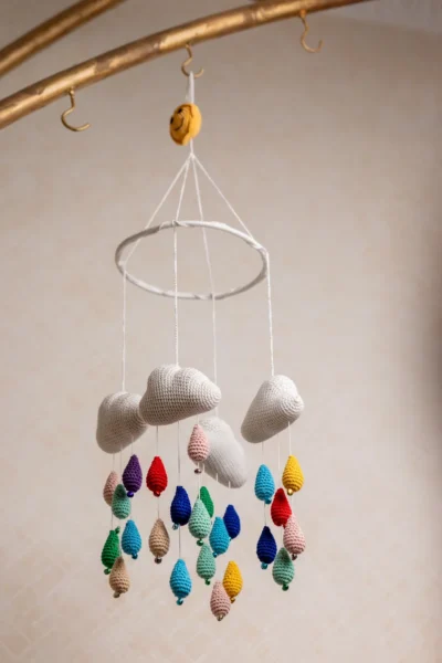 Crochet cloud and raindrops cot hanging showing full mobile with colourful raindrop strands handmade ethical nursery decor Australia