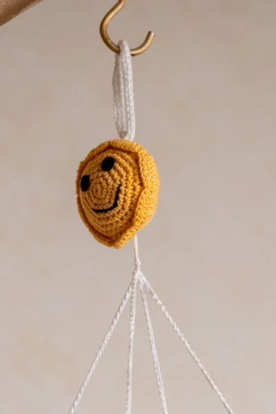 Crochet cloud and raindrops cot hanging showing full mobile with colourful raindrop strands handmade ethical nursery decor Australia