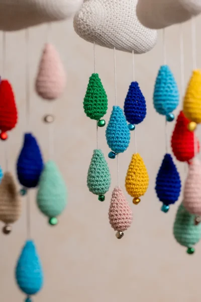 Crochet cloud and raindrops cot hanging showing full mobile with colourful raindrop strands handmade ethical nursery decor Australia