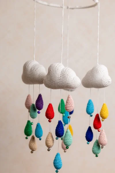 Crochet cloud and raindrops cot hanging showing full mobile with colourful raindrop strands handmade ethical nursery decor Australia