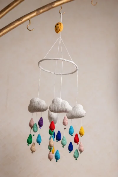 Crochet cloud and raindrops cot hanging showing full mobile with colourful raindrop strands handmade ethical nursery decor Australia