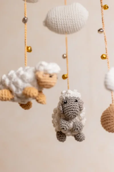 Crochet dreamy sheep cot hanging showing full mobile with fluffy white sheep and gentle cloud motifs handmade nursery decor Melbourne