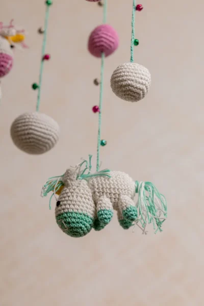 Pink and green unicorn crochet nursery mobile shown in nursery handmade baby shower gift unique colour Melbourne Australia