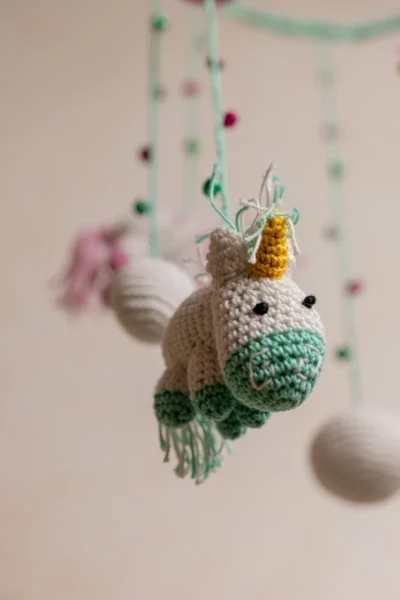 Pink and green unicorn crochet nursery mobile shown in nursery handmade baby shower gift unique colour Melbourne Australia