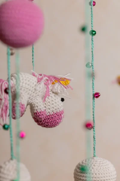 Pink and green unicorn crochet nursery mobile shown in nursery handmade baby shower gift unique colour Melbourne Australia
