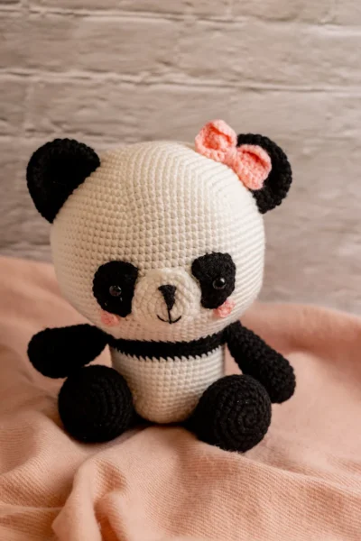 Handmade crochet amigurumi panda bear with pink bow soft black and white toy with delicate bow detail artisan made gift Australia