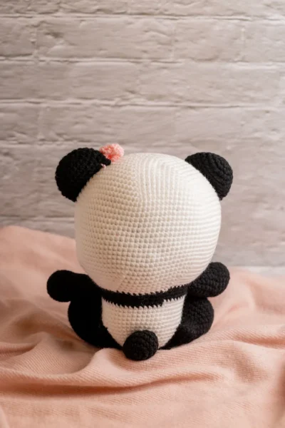 Handmade crochet amigurumi panda bear with pink bow soft black and white toy with delicate bow detail artisan made gift Australia