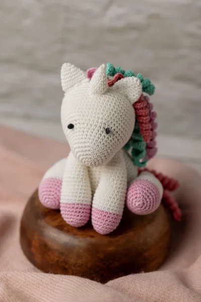 Handmade crochet amigurumi unicorn with soft white body and vibrant rainbow mane made by artisan crafters magical kids gift Australia