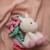 Handmade crochet amigurumi unicorn with soft white body and vibrant rainbow mane made by artisan crafters magical kids gift Australia