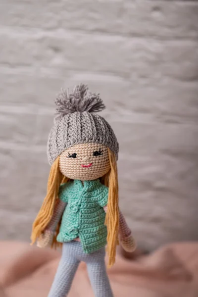 Handmade crochet amigurumi winter doll wearing cosy hat coat and scarf made by artisan crafters soft toy gift Australia