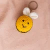 Close up of handmade honey bee crochet keyring showing yellow black stripe and wing stitch detail