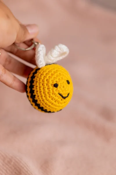 Yellow and black crochet bee keychain showing wing and stripe detail handmade ethical gift Australia