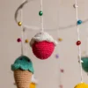 Crochet ice cream cupcake cot hanging showing full mobile with colourful sweet treat characters handmade ethical nursery decor