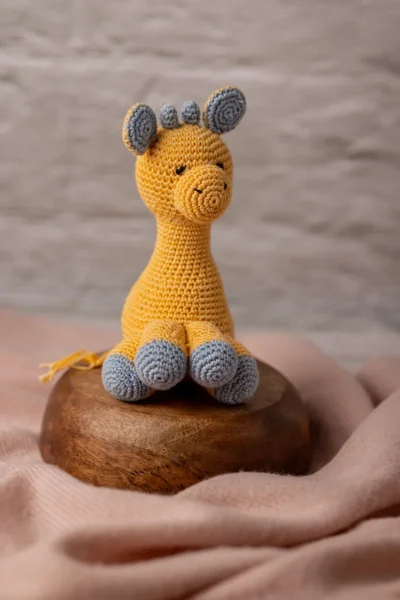 Handmade crochet Ingu giraffe soft toy with yellow and brown spot pattern long neck and gentle stitched face artisan made Australia