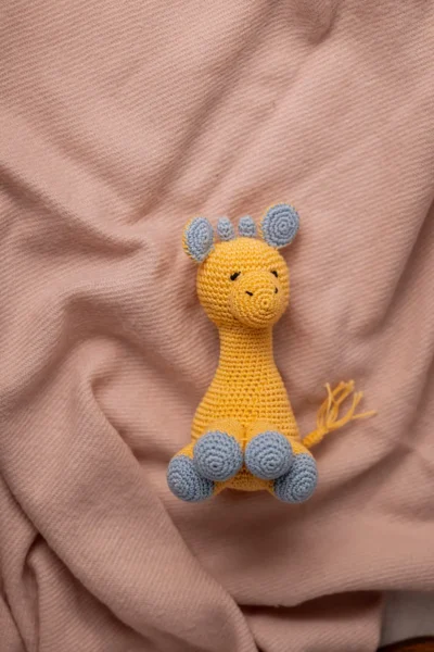 Handmade crochet Ingu giraffe soft toy with yellow and brown spot pattern long neck and gentle stitched face artisan made Australia