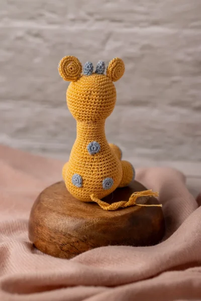 Handmade crochet Ingu giraffe soft toy with yellow and brown spot pattern long neck and gentle stitched face artisan made Australia