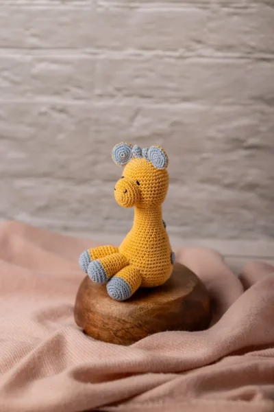 Handmade crochet Ingu giraffe soft toy with yellow and brown spot pattern long neck and gentle stitched face artisan made Australia