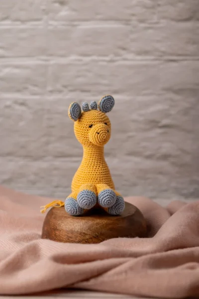 Handmade crochet Ingu giraffe soft toy with yellow and brown spot pattern long neck and gentle stitched face artisan made Australia