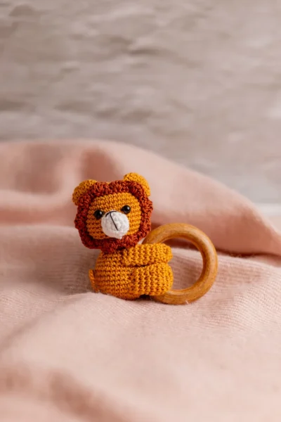 Crochet lion toy and rattle set shown together displaying warm mane detail and coordinated design handmade baby shower gift Melbourne