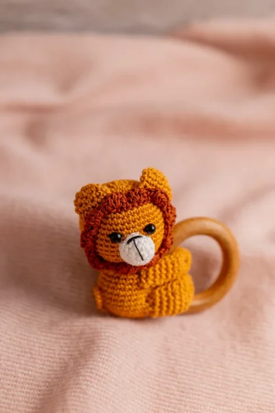 Handmade crochet lion rattle and toy set with soft lion companion and matching sensory rattle made by artisan crafters newborn gift Australia
