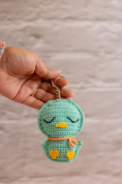 Green crochet duckling bag charm handmade showing full duck body and tail detail