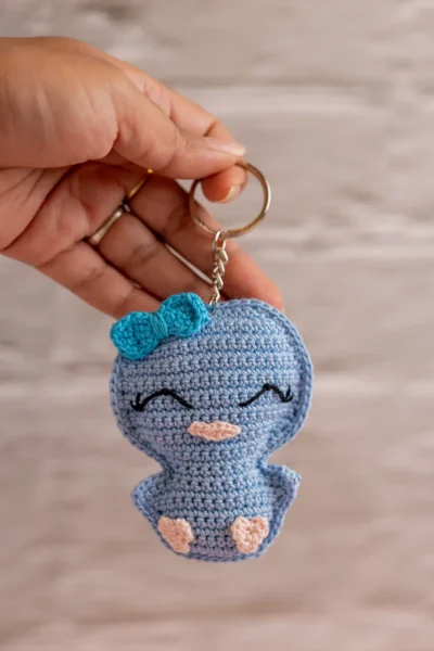 Blue crochet duckling keyring lying flat showing compact size handmade gift under 10 dollars Australia