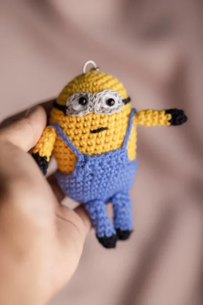 Handmade crochet two eyed yellow character keyring with goggles and overalls made by artisan crafters Australia