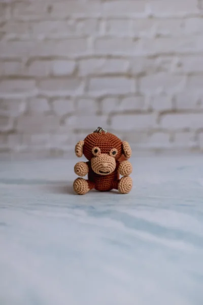 Brown crochet monkey keychain showing full monkey figure handmade ethical gift for animal lovers Australia
