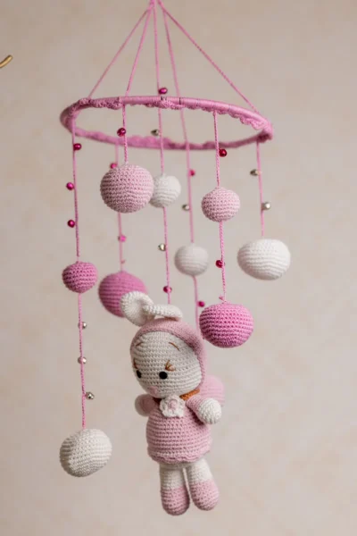 Handmade crochet pink bunny nursery mobile with soft white and pink rabbit made by artisan women in India Australia
