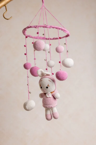 Handmade crochet pink bunny nursery mobile with soft white and pink rabbit made by artisan women in India Australia