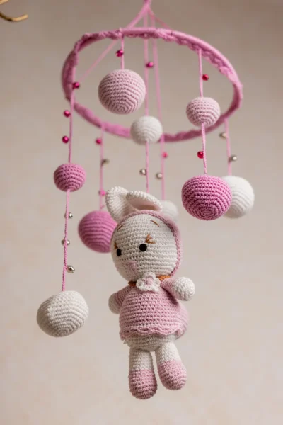 Handmade crochet pink bunny nursery mobile with soft white and pink rabbit made by artisan women in India Australia