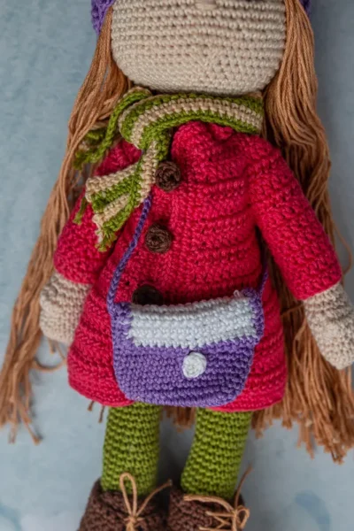 Full body view of Pollie crochet doll showing striped dress detail long soft yarn hair and amigurumi proportions Melbourne