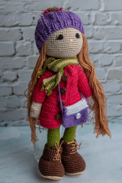 Full body view of Pollie crochet doll showing striped dress detail long soft yarn hair and amigurumi proportions Melbourne