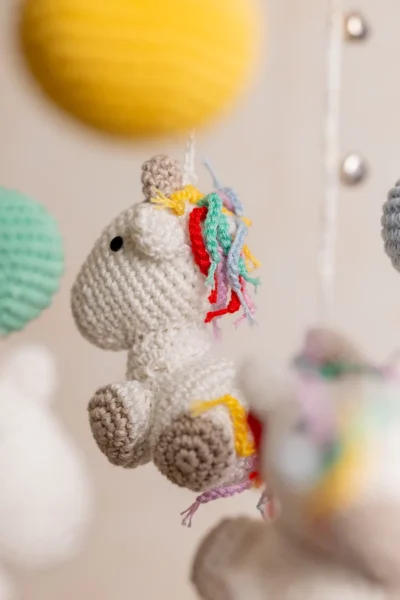 Handmade crochet rainbow unicorn nursery mobile with white unicorn and rainbow mane made by artisan women in India Australia