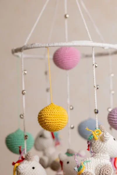 Handmade crochet rainbow unicorn nursery mobile with white unicorn and rainbow mane made by artisan women in India Australia