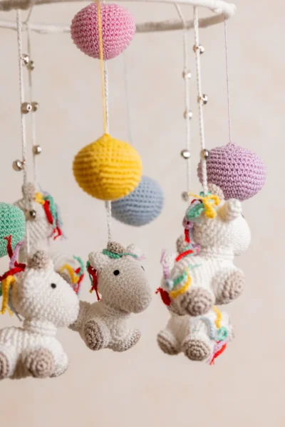 Handmade crochet rainbow unicorn nursery mobile with white unicorn and rainbow mane made by artisan women in India Australia