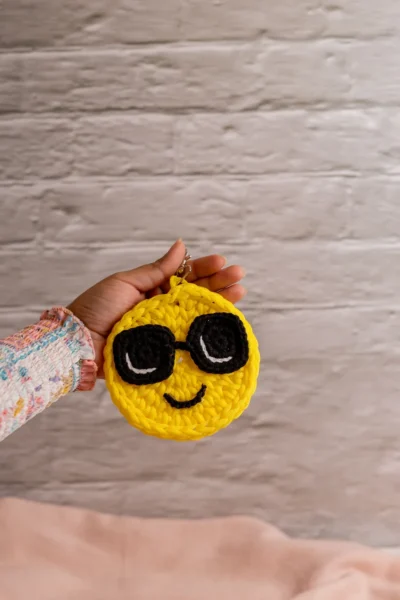 Handmade crochet yellow smiley face keyring with stitched smile made by artisan crafters Australia