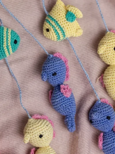 Handmade crochet zoo animal nursery mobile featuring colourful crochet animals made by artisan women in India Australia