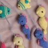 Handmade crochet zoo animal nursery mobile featuring colourful crochet animals made by artisan women in India Australia