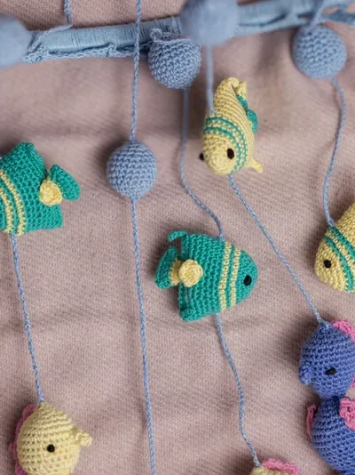 Handmade crochet zoo animal nursery mobile featuring colourful crochet animals made by artisan women in India Australia