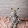 Handmade crochet Zippy the zebra with classic black and white stripes and vibrant rainbow mane made by artisan crafters kids gift Australia