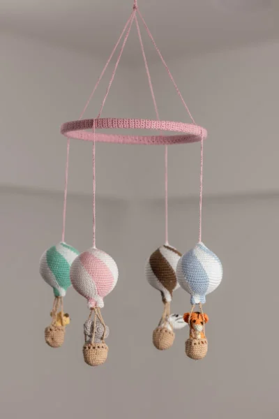 Handmade crochet zoo animal nursery mobile featuring colourful crochet animals made by artisan women in India Australia