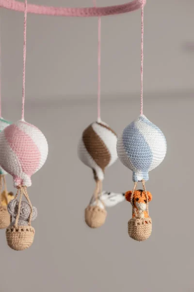 Handmade crochet zoo animal nursery mobile featuring colourful crochet animals made by artisan women in India Australia