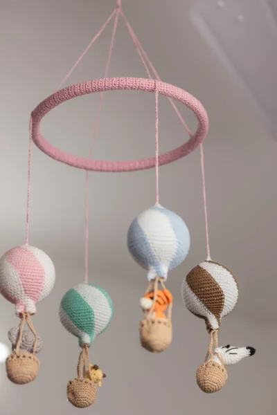 Handmade crochet zoo animal nursery mobile featuring colourful crochet animals made by artisan women in India Australia