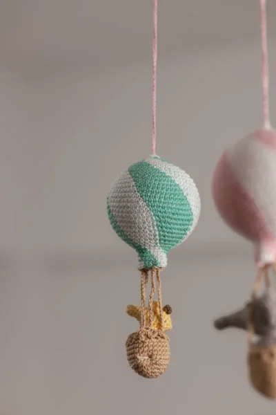 Handmade crochet zoo animal nursery mobile featuring colourful crochet animals made by artisan women in India Australia